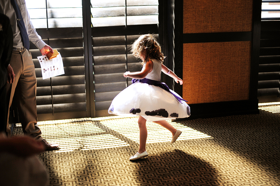 a little girl twirling in a beam of sunshine